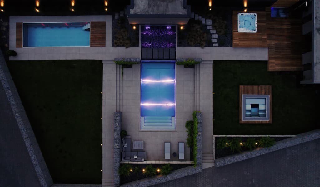 Luxury garden swimming pool IMAGINOX in night with lights on