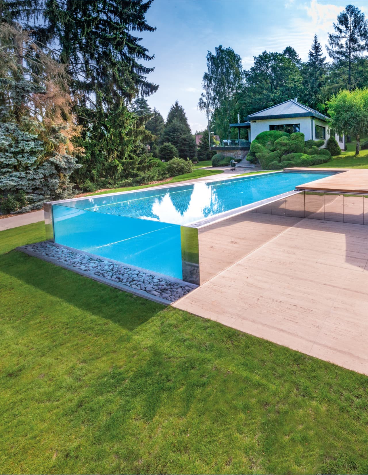 Posh pool with a glass wall in the garden