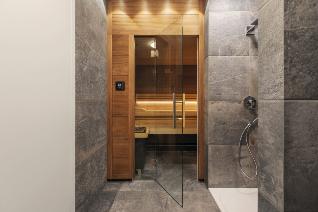 Build in sauna with luxury combination of wood and stone paneling