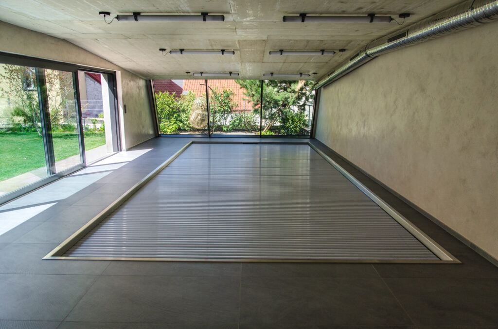 Luxury swimming pool with a lamella cover